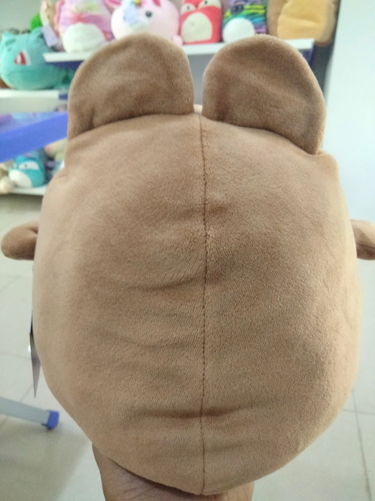 Miniso Mini Family Penguin plush toy wearing a brown rabbit costume.