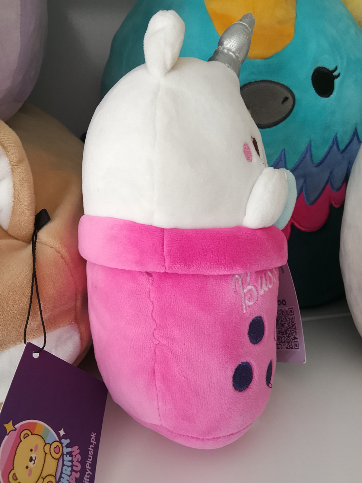 bubble tea cup featuring a unicorn character plush toy.