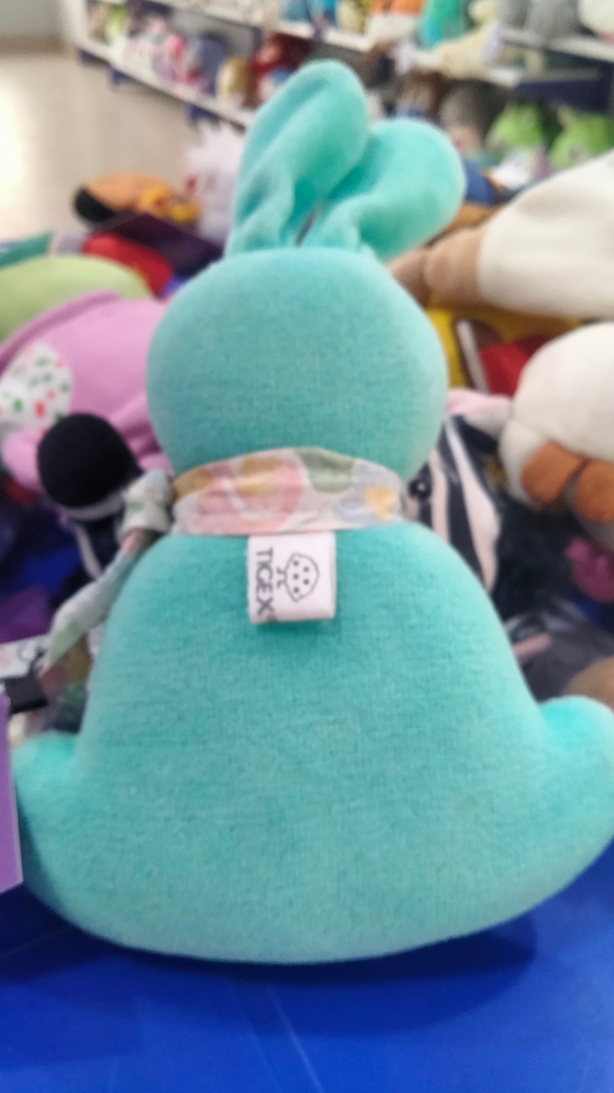 This plush toy is a turquoise IKEA GREJSIMOJS soft toy.