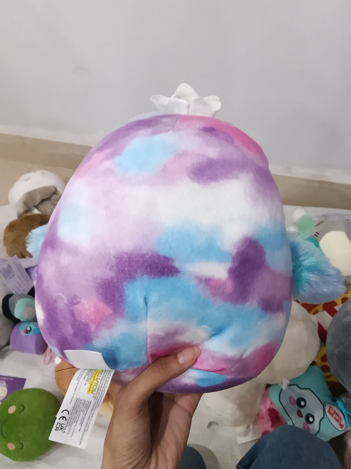 Squishmallows Tomara the Penguin tie-dye plush toy.