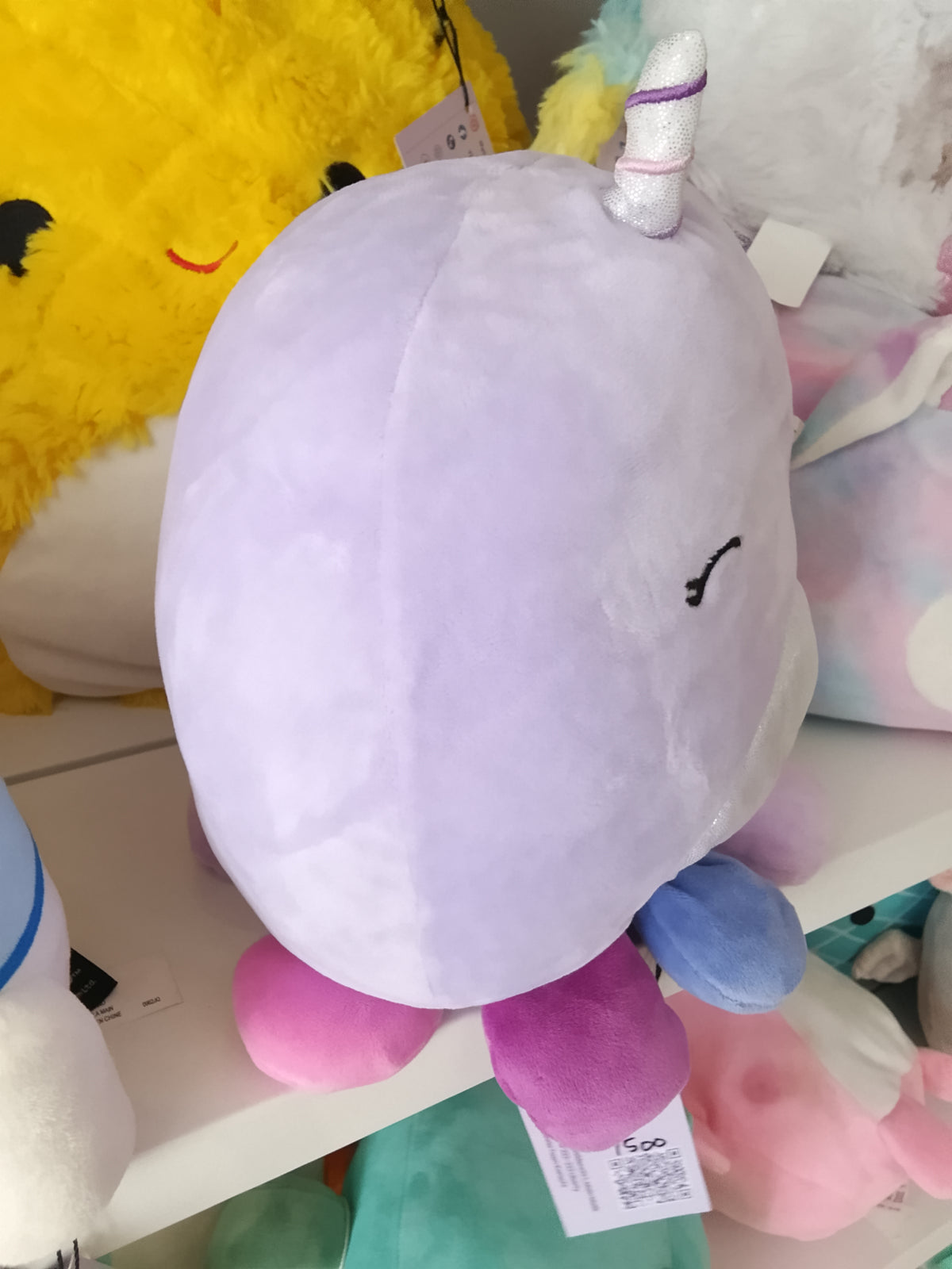 Squishmallows Naomi the Lavender Narwhal plush toy.