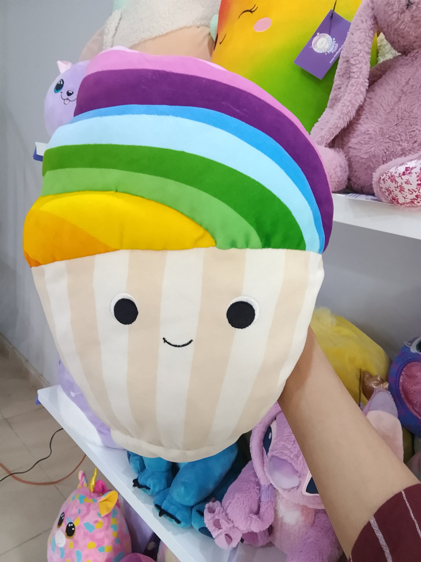 Squishmallows rainbow snow cupcake plush toy.