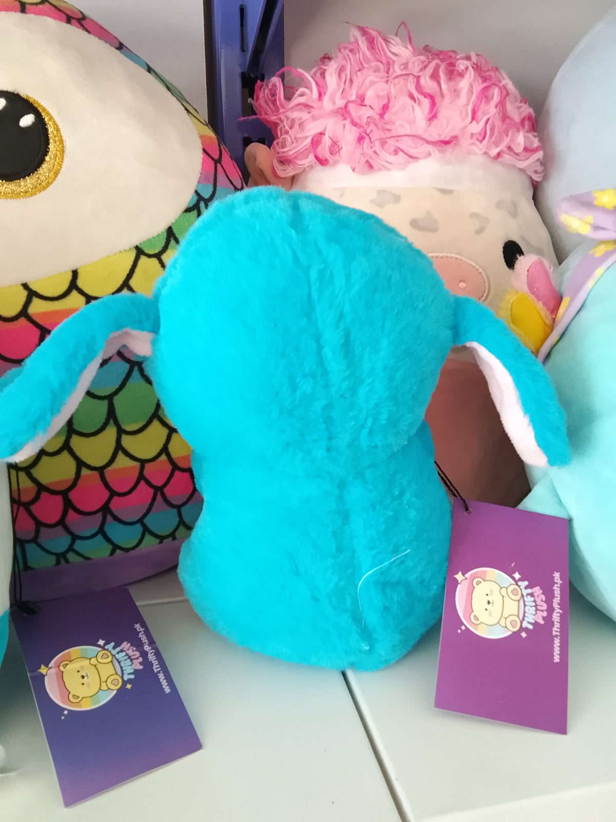 Stitch holding a smaller white duck Plush toy.