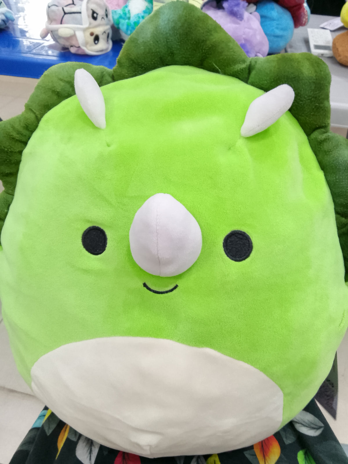 Squishmallows plush toy featuring Tristan the Green Triceratops dinosaur.