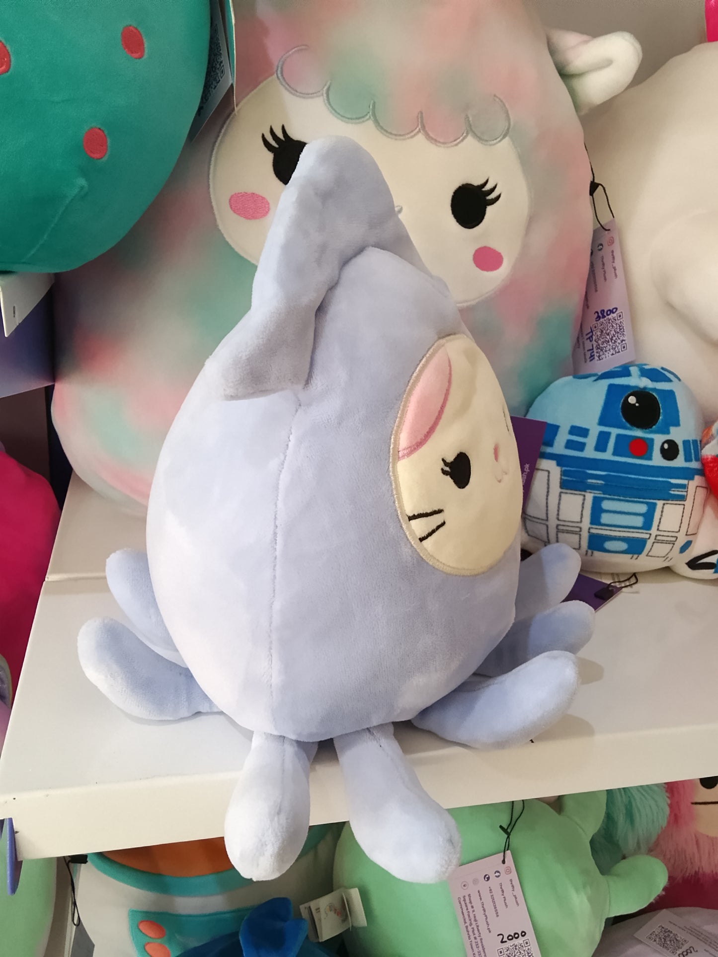 Squishmallow collectible plush toy known as Karina the Cat in a Stacy Squid costume.