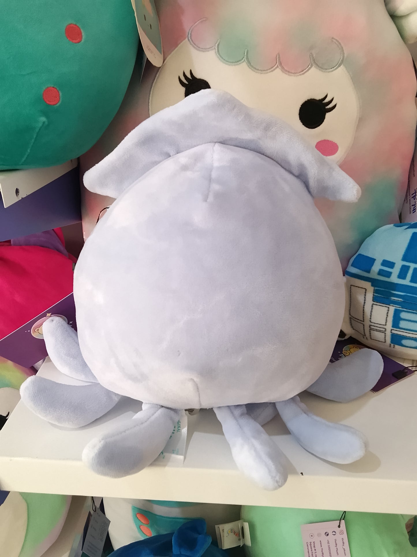 Squishmallow collectible plush toy known as Karina the Cat in a Stacy Squid costume.