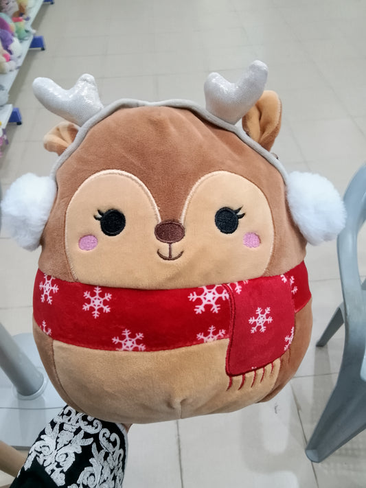 Squishmallows plush toy Darla the Fawn, complete with holiday earmuffs and a red scarf.