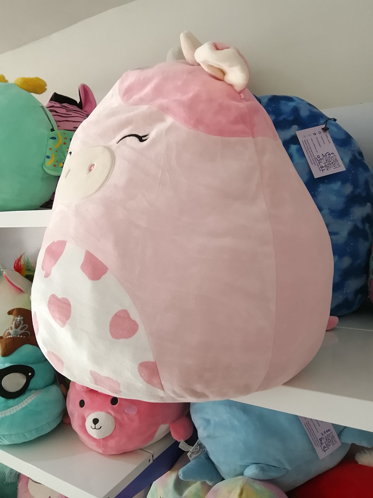Squishmallows Clay the Pink Cow plush toy.