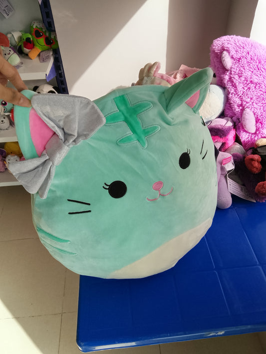 Squishmallows plush of Tres'zure the Cat, mint green color and a glittery silver bow