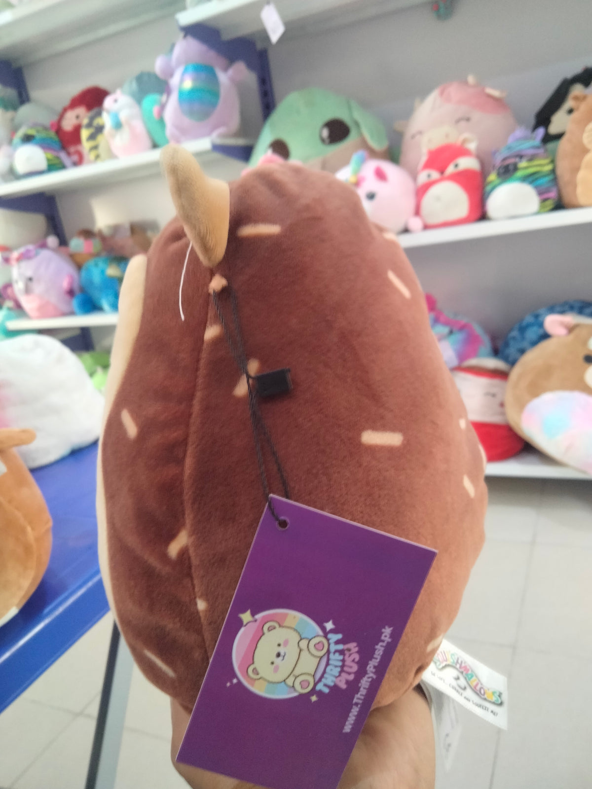 Squishmallows Hans the Hedgehog brown plush toy.