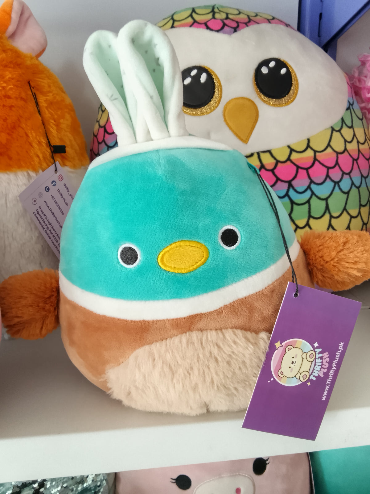 Squishmallows Daksa the Duck Easter plush bunny ears and a fuzzy belly.