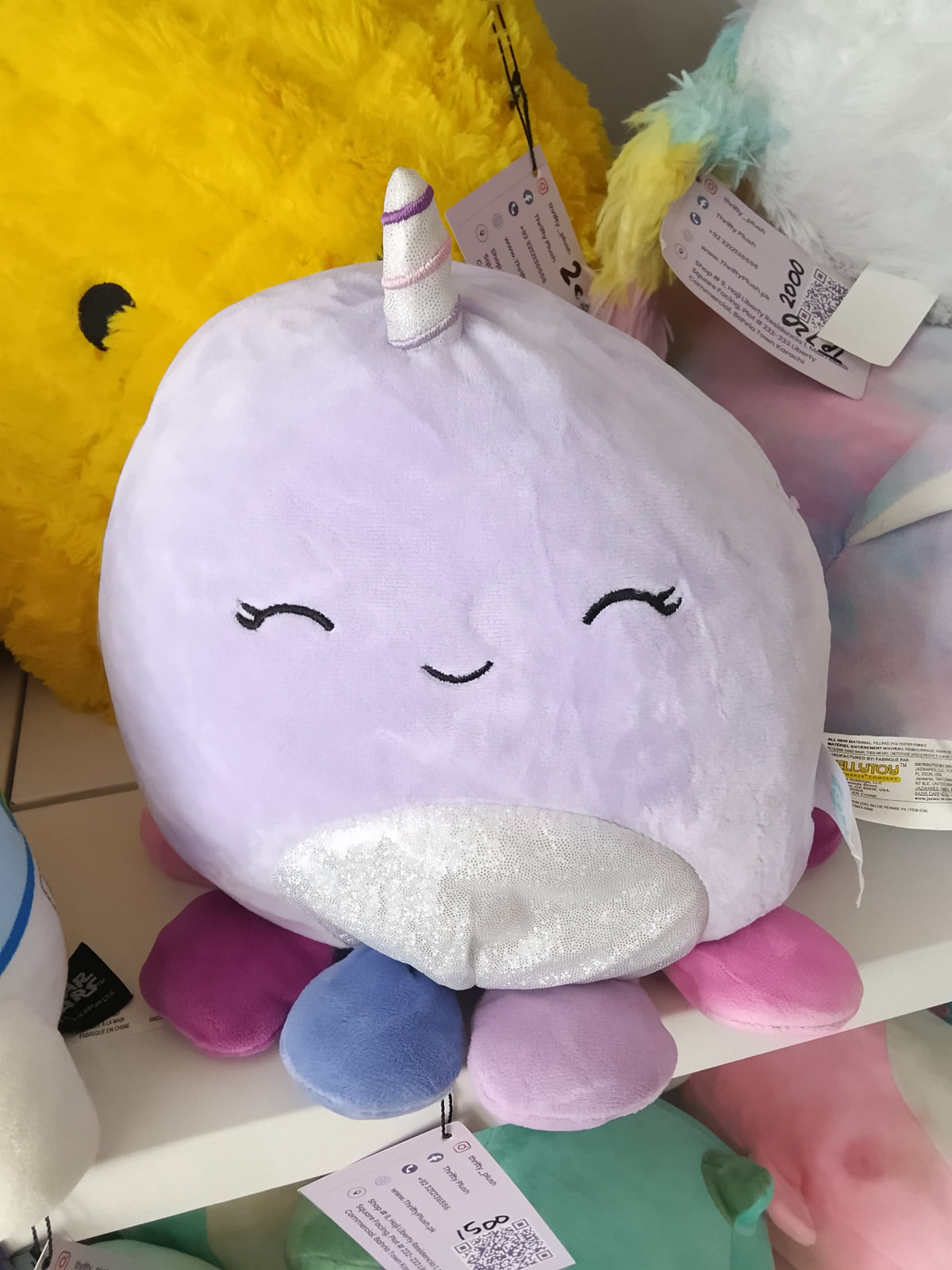 Squishmallows Naomi the Lavender Narwhal plush toy.