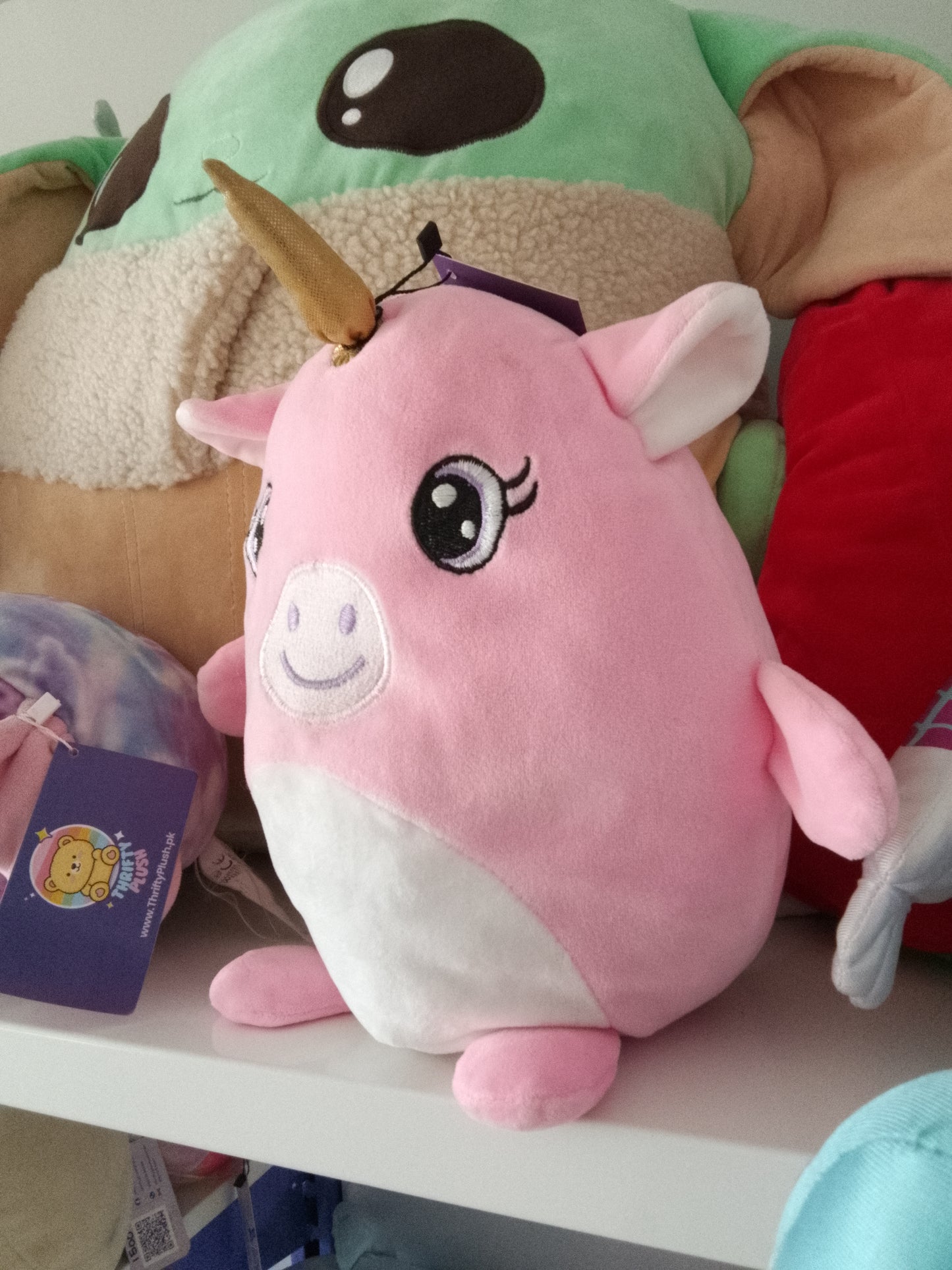 Pink unicorn plush pillow toy.