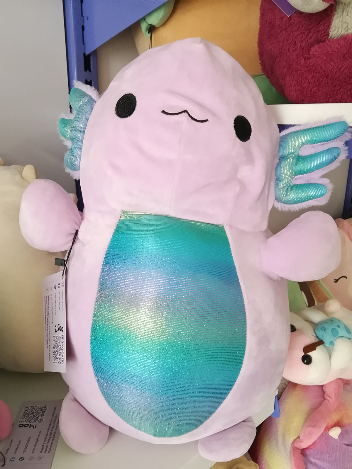 Monica the Axolotl, a light purple character from the Squishmallows Hug Mees line by Kellytoy.