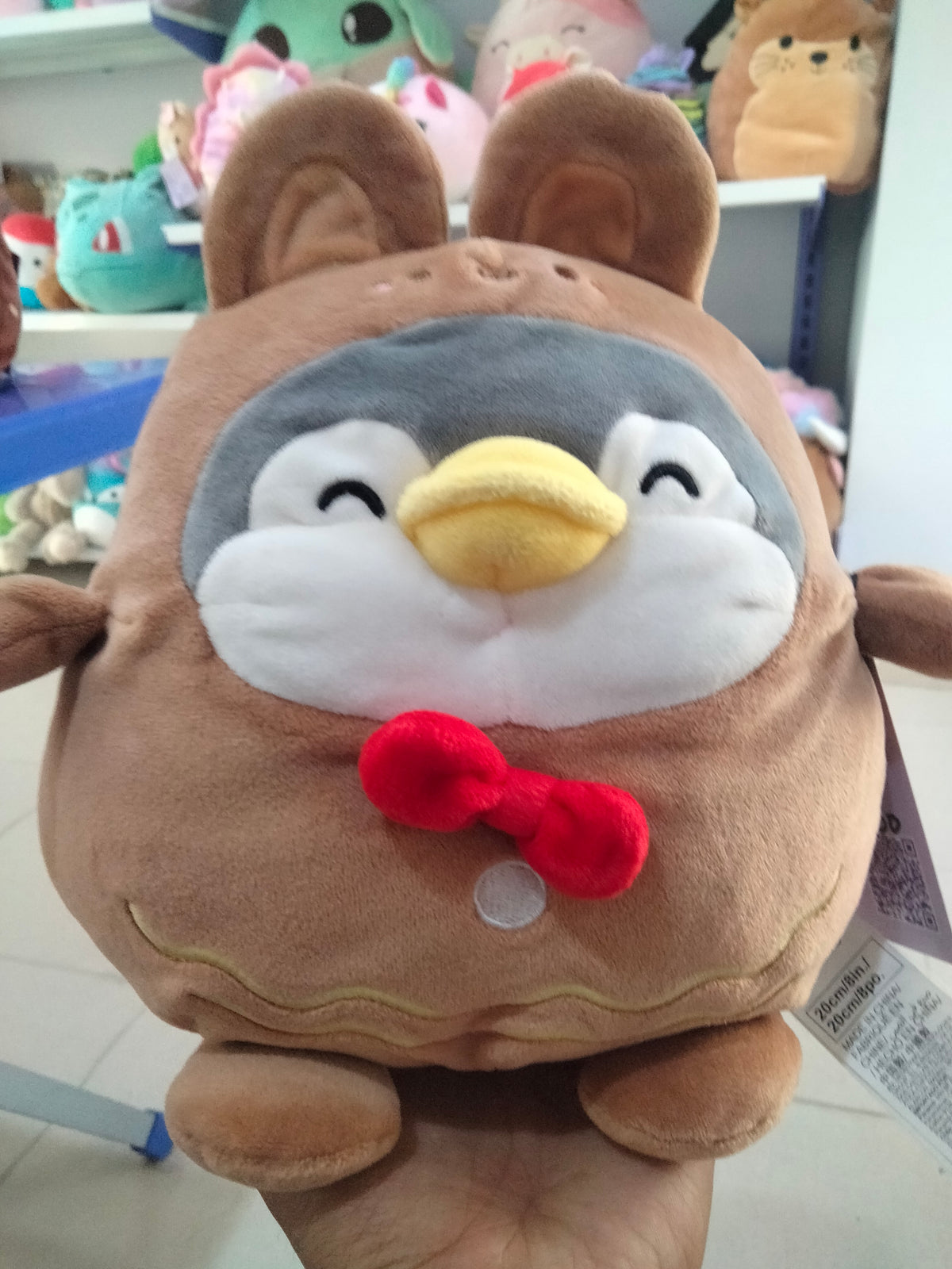Miniso Mini Family Penguin plush toy wearing a brown rabbit costume.