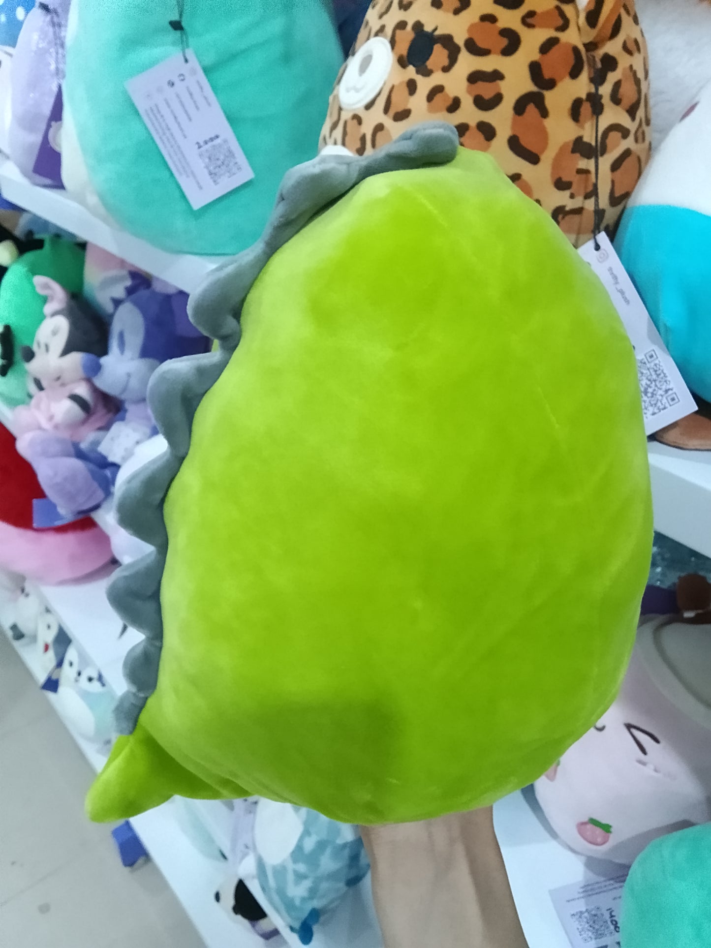 Squishmallows green dinosaur character, likely Danny or Arlie plush toy.
