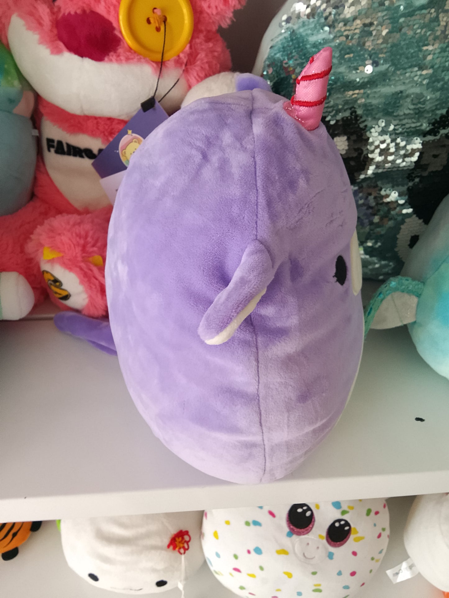 Squishmallows Astrid The Unicorn with Sleepy Eyes plush toy.