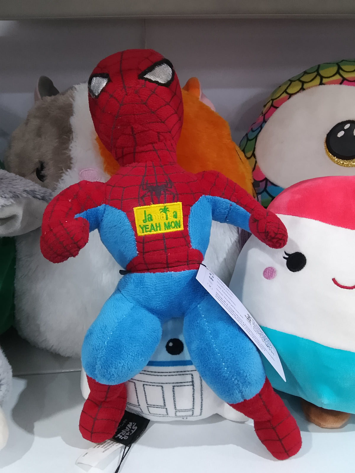 Spider-Man "JAMAICA YEAH MON" patch on its chest plush toy.