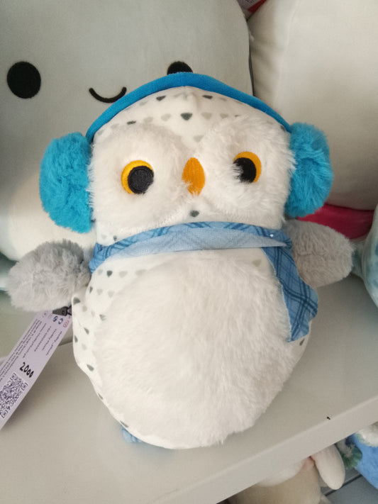 White snowy owl wearing blue earmuffs and a blue plaid scarf plush toy.