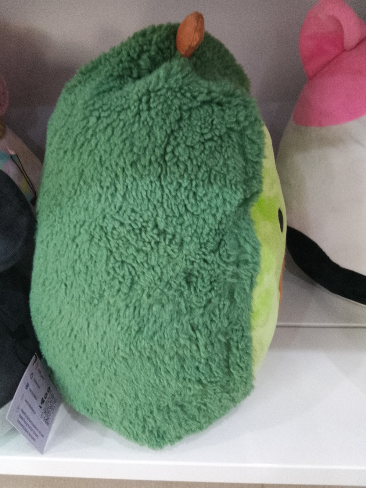Squishmallows  Austin the Avocado plush toy from the FuzzAMallows collection.