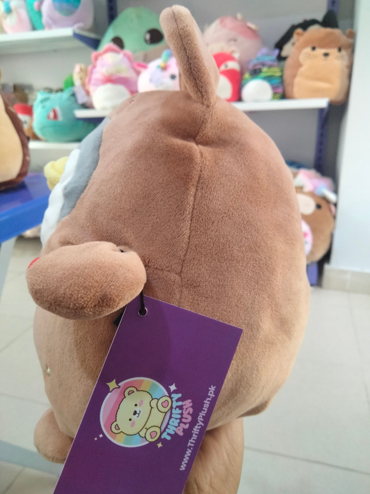 Miniso Mini Family Penguin plush toy wearing a brown rabbit costume.