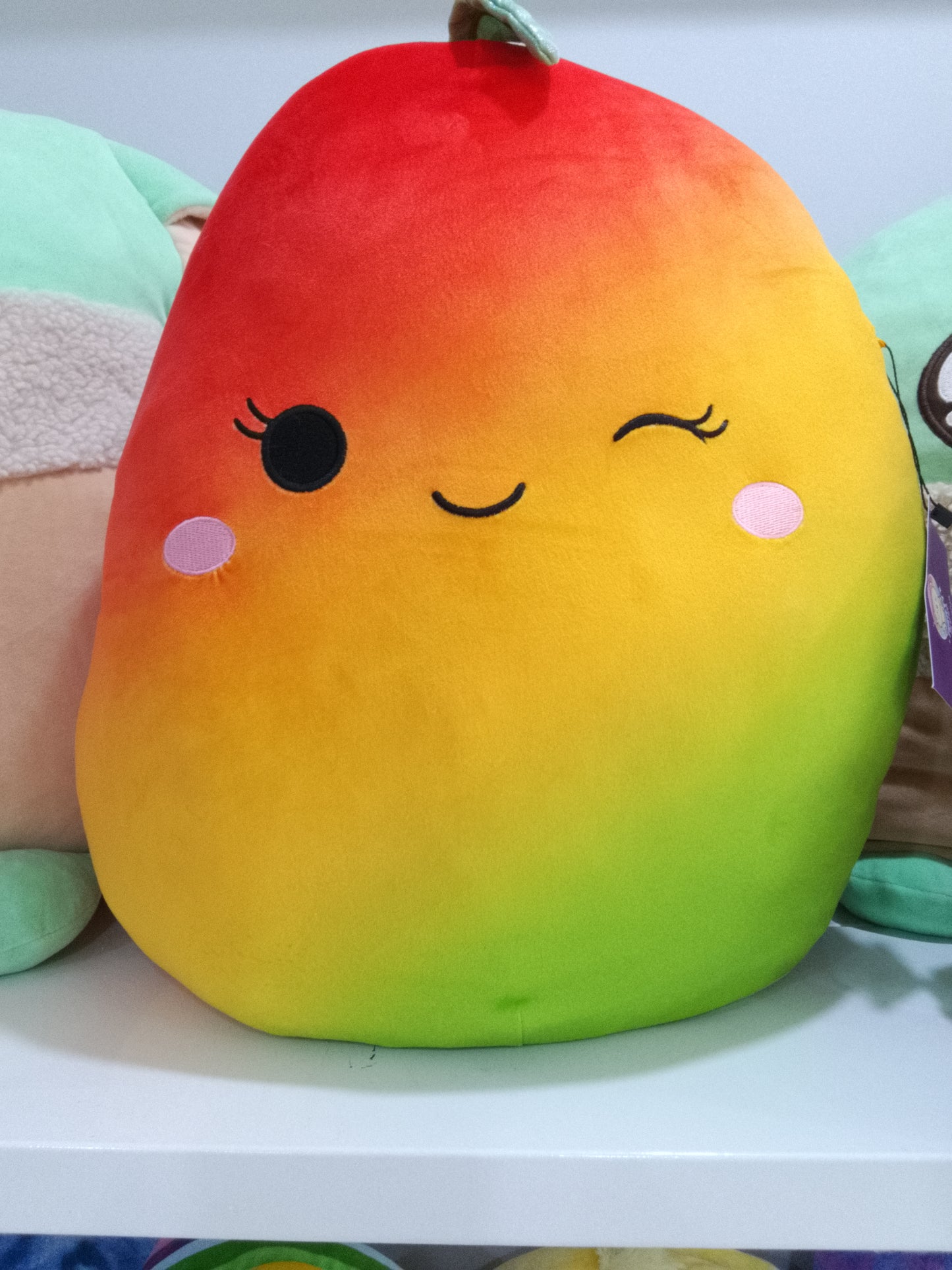Squishmallows Ximena the Mango plush toy.
