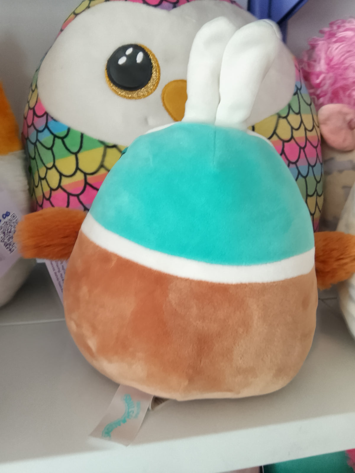 Squishmallows Daksa the Duck Easter plush bunny ears and a fuzzy belly.