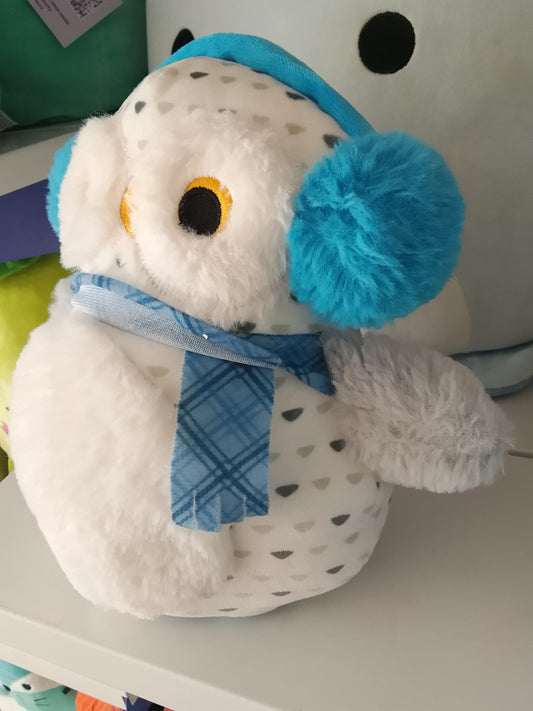 White snowy owl wearing blue earmuffs and a blue plaid scarf plush toy.