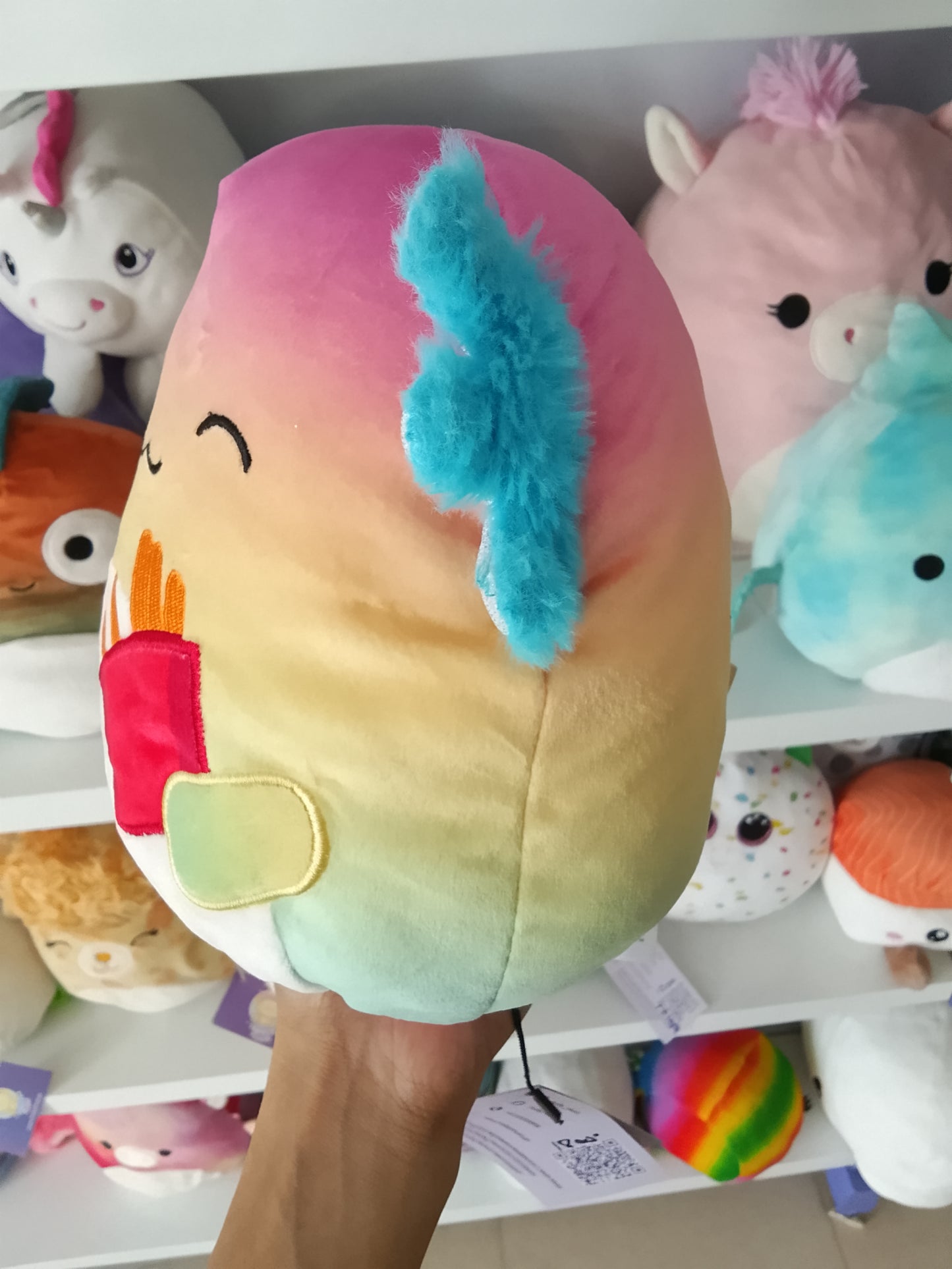 Squishmallows Flip-A-Mallows Aika the Axolotl plush rainbow design and holding a French fry carton.