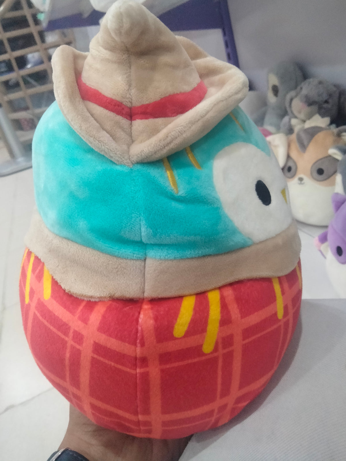 This is a Squishmallows Winston the Scarecrow Owl plush toy.