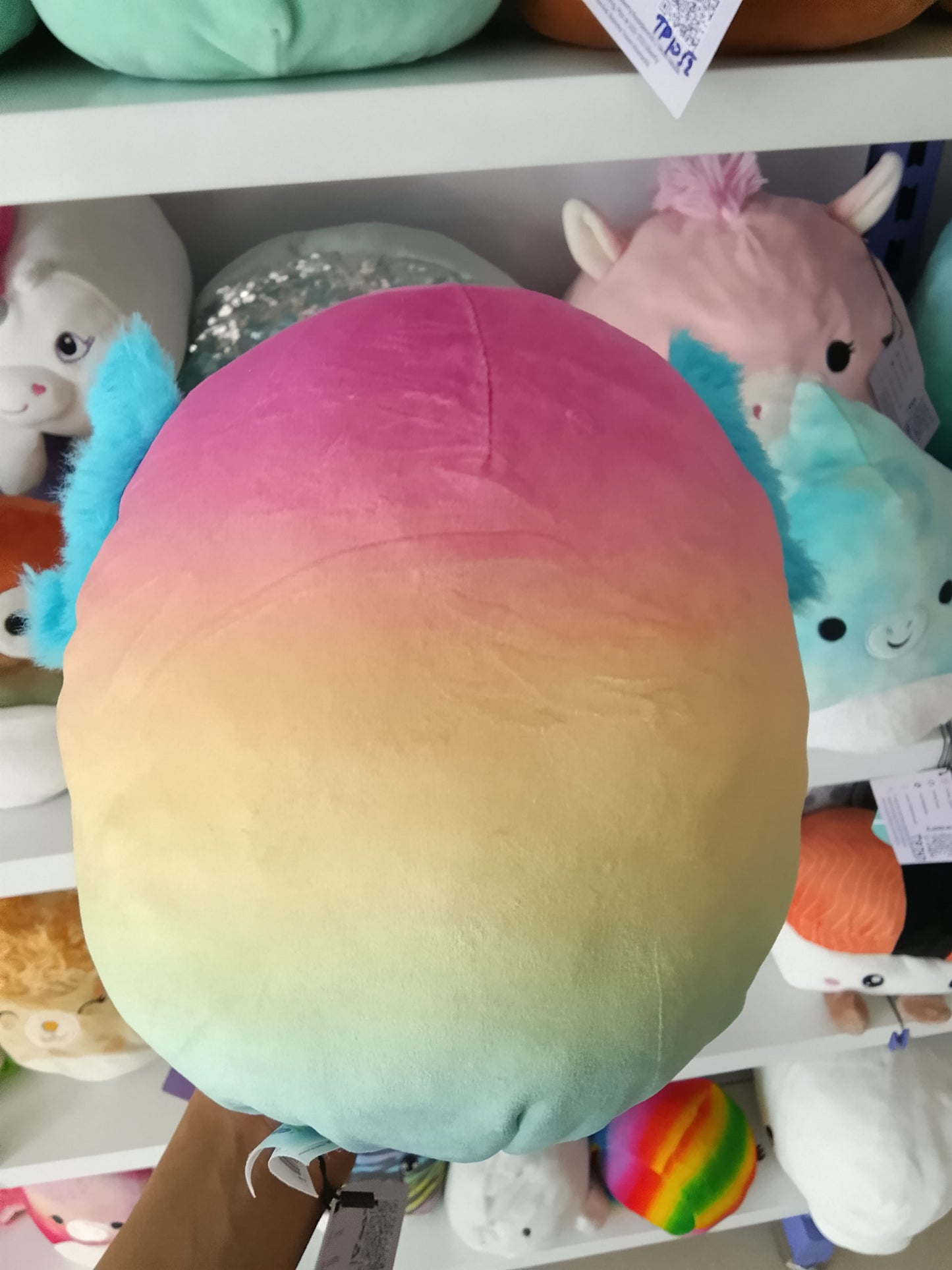 Squishmallows Flip-A-Mallows Aika the Axolotl plush rainbow design and holding a French fry carton.