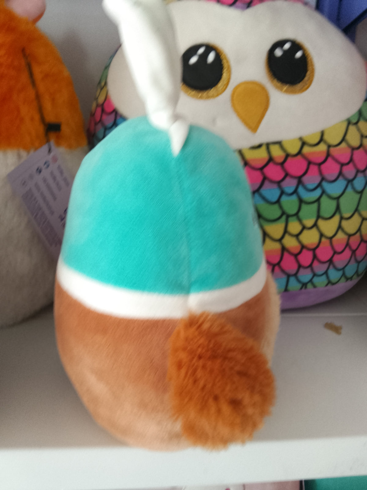 Squishmallows Daksa the Duck Easter plush bunny ears and a fuzzy belly.