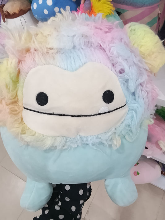 Squishmallows Zozo the Bigfoot plush toy in blue with rainbow hair.