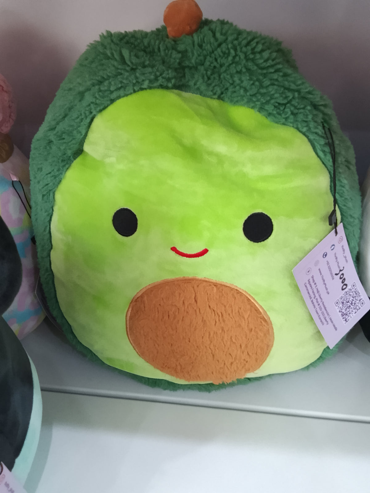 Squishmallows  Austin the Avocado plush toy from the FuzzAMallows collection.