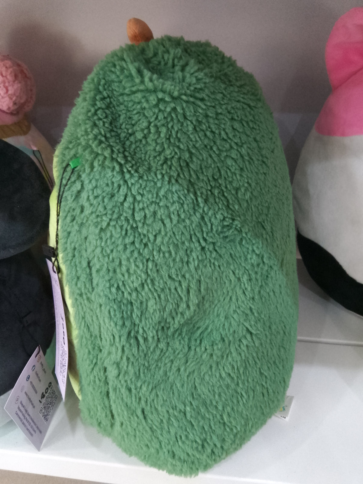 Squishmallows  Austin the Avocado plush toy from the FuzzAMallows collection.