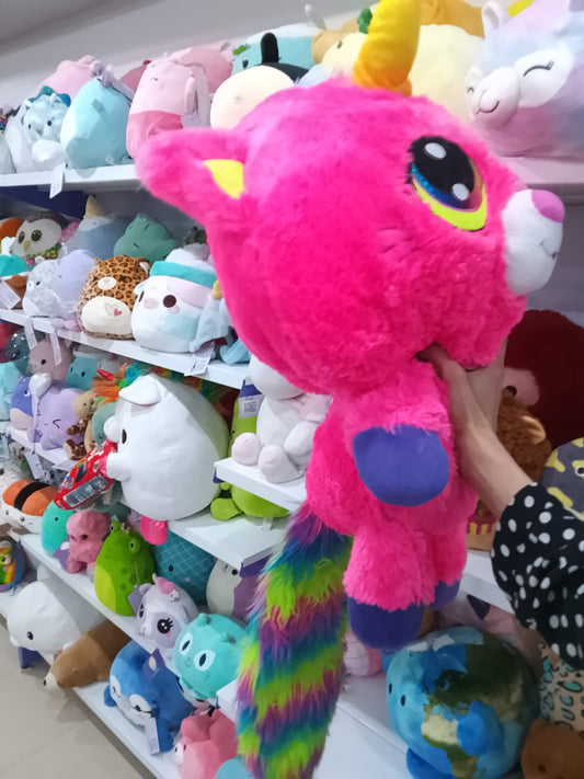Princess Pink Kittycorn bright pink fur, a yellow unicorn horn, and a rainbow-colored mane and tail.