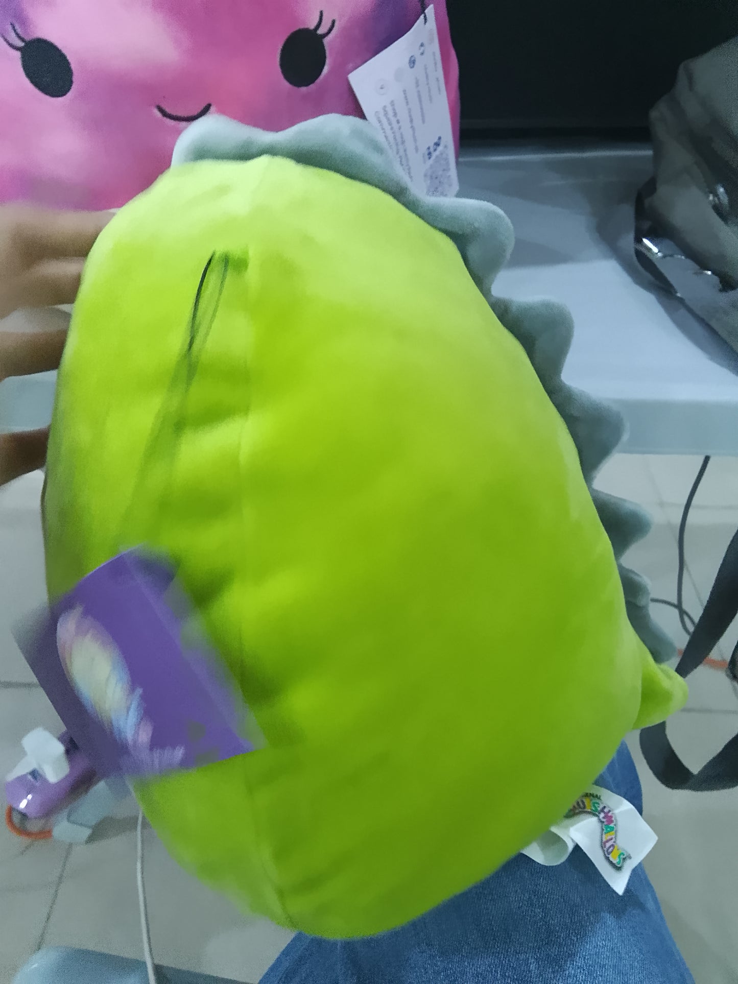 Squishmallows plush toy featuring Arlie the green dinosaur.