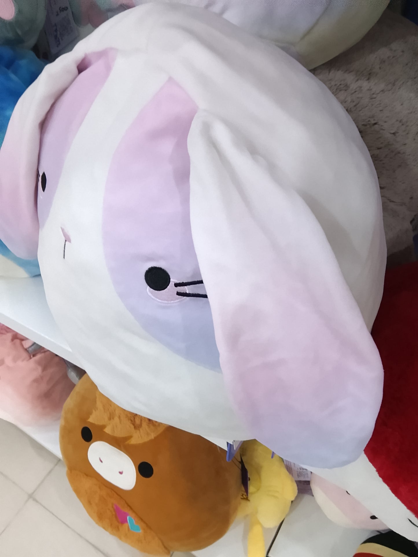 Squishmallows Lavada the Bunny plush toys, white bodies with pink and purple ombre patches on their ears and sides.