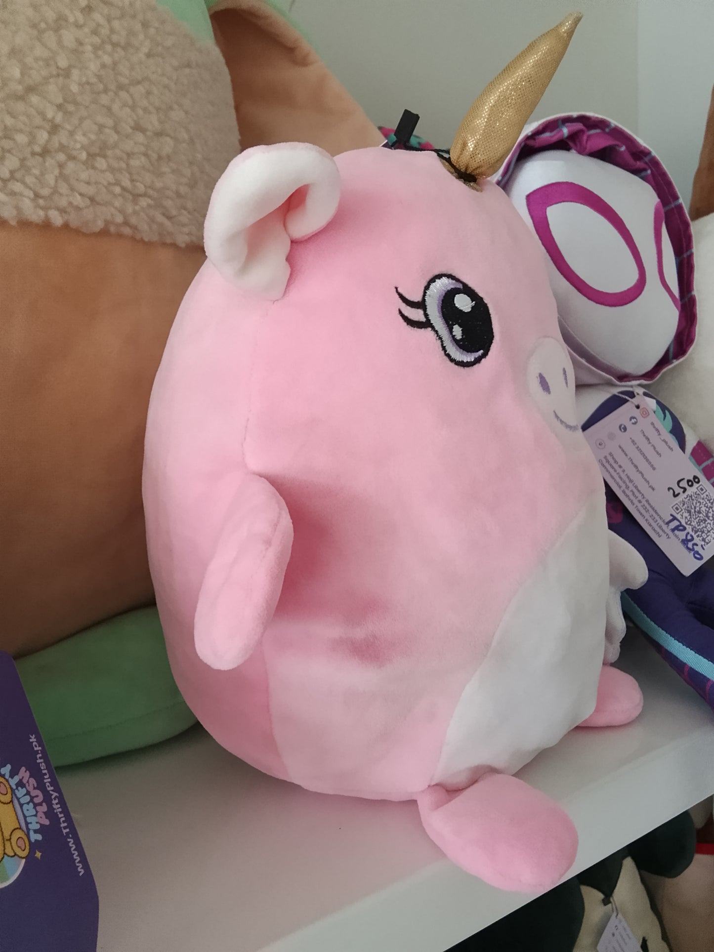 Pink unicorn plush pillow toy.