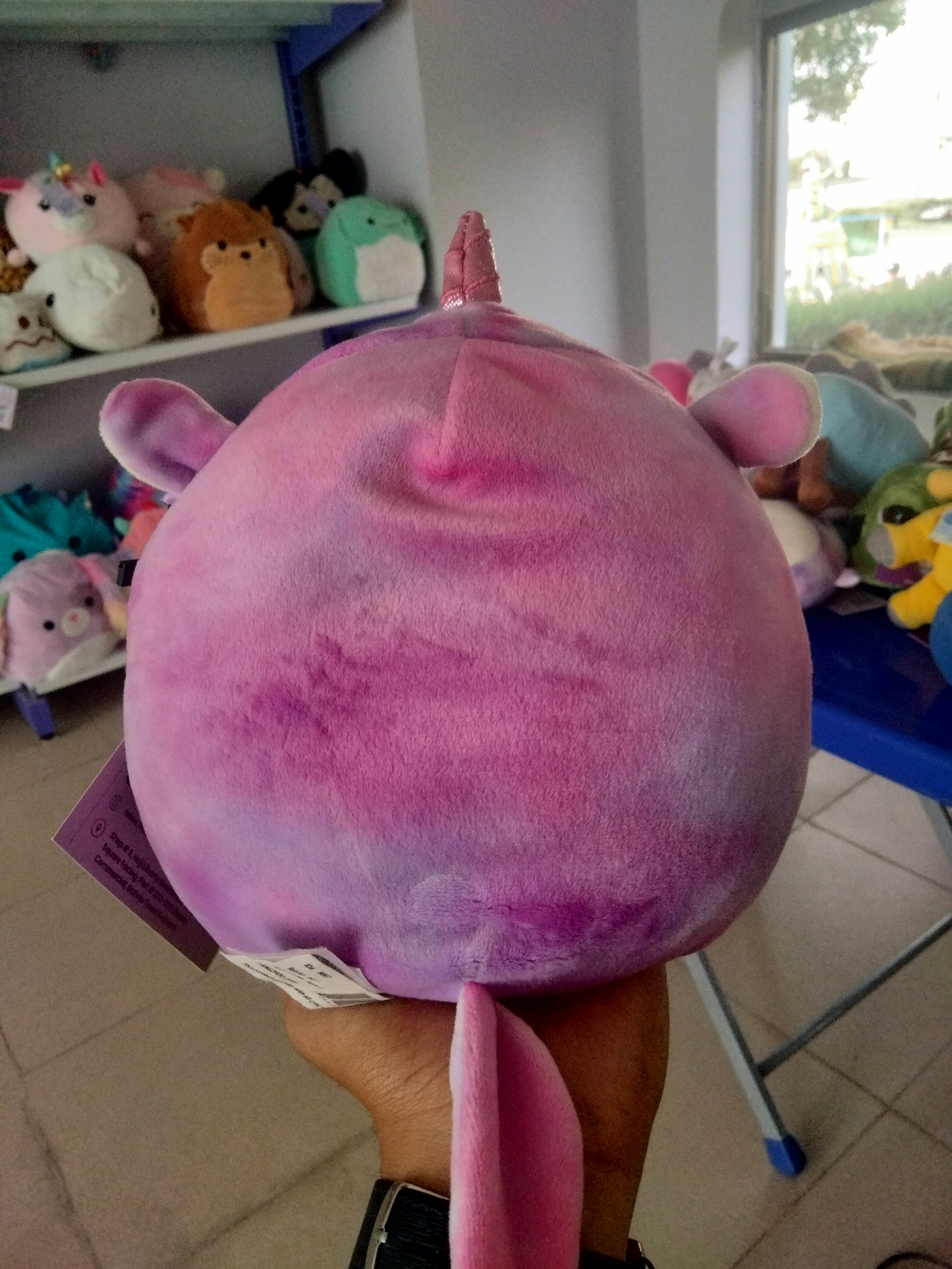 Squishmallows Astrid The Unicorn with Sleepy Eyes plush toy.