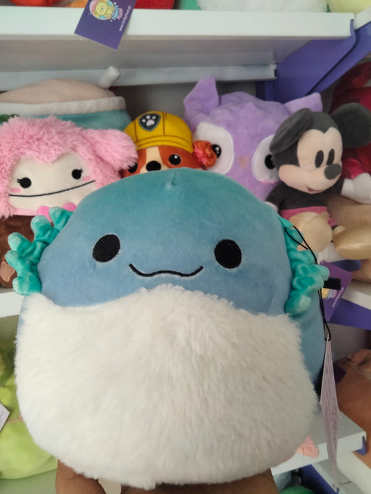 Squishmallows plush toy, specifically the character Cella the Teal Bearded Dragon.