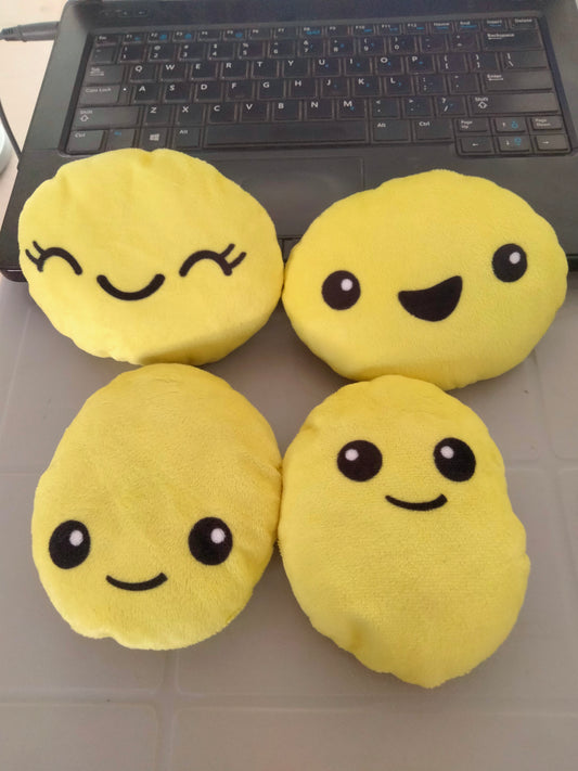 smiley emoji pillow with plush yellow fabric.