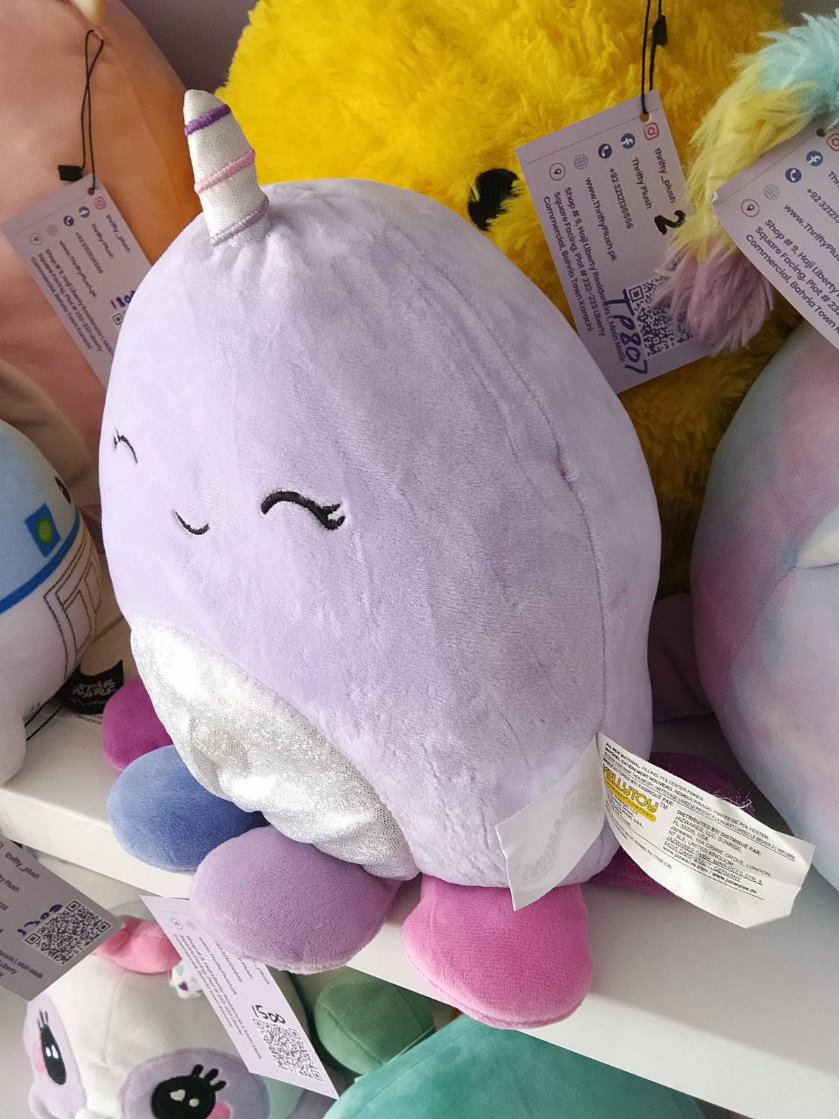 Squishmallows Naomi the Lavender Narwhal plush toy.