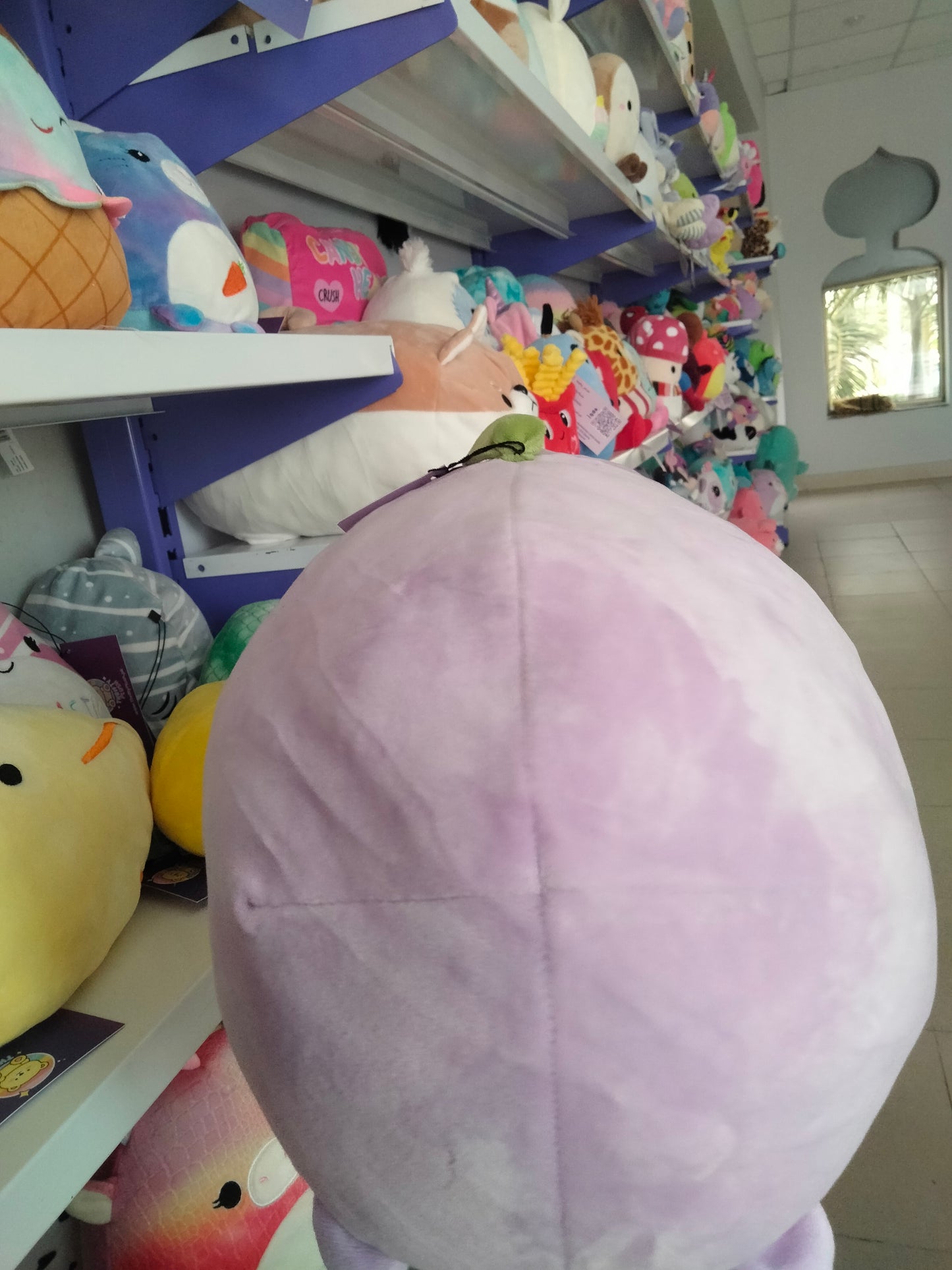 A soft, purple fruit-themed plush toy from Thrifty Plush.