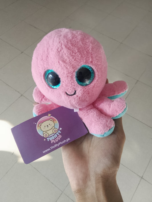 Ty Beanie Boo Sheldon plush toy featuring pink fur and blue glittery eyes.