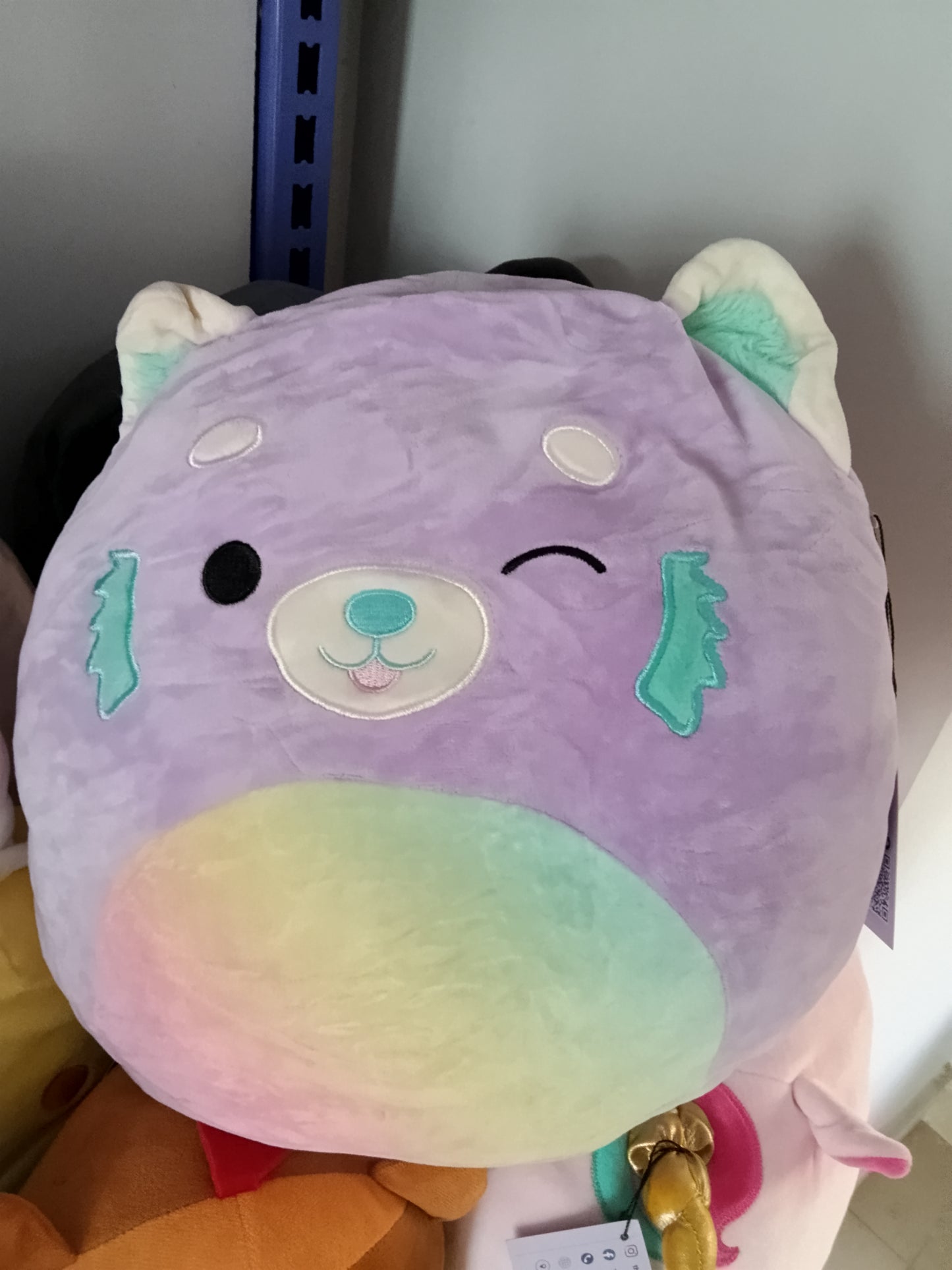Squishmallows Lexis the Red Panda plush toy.