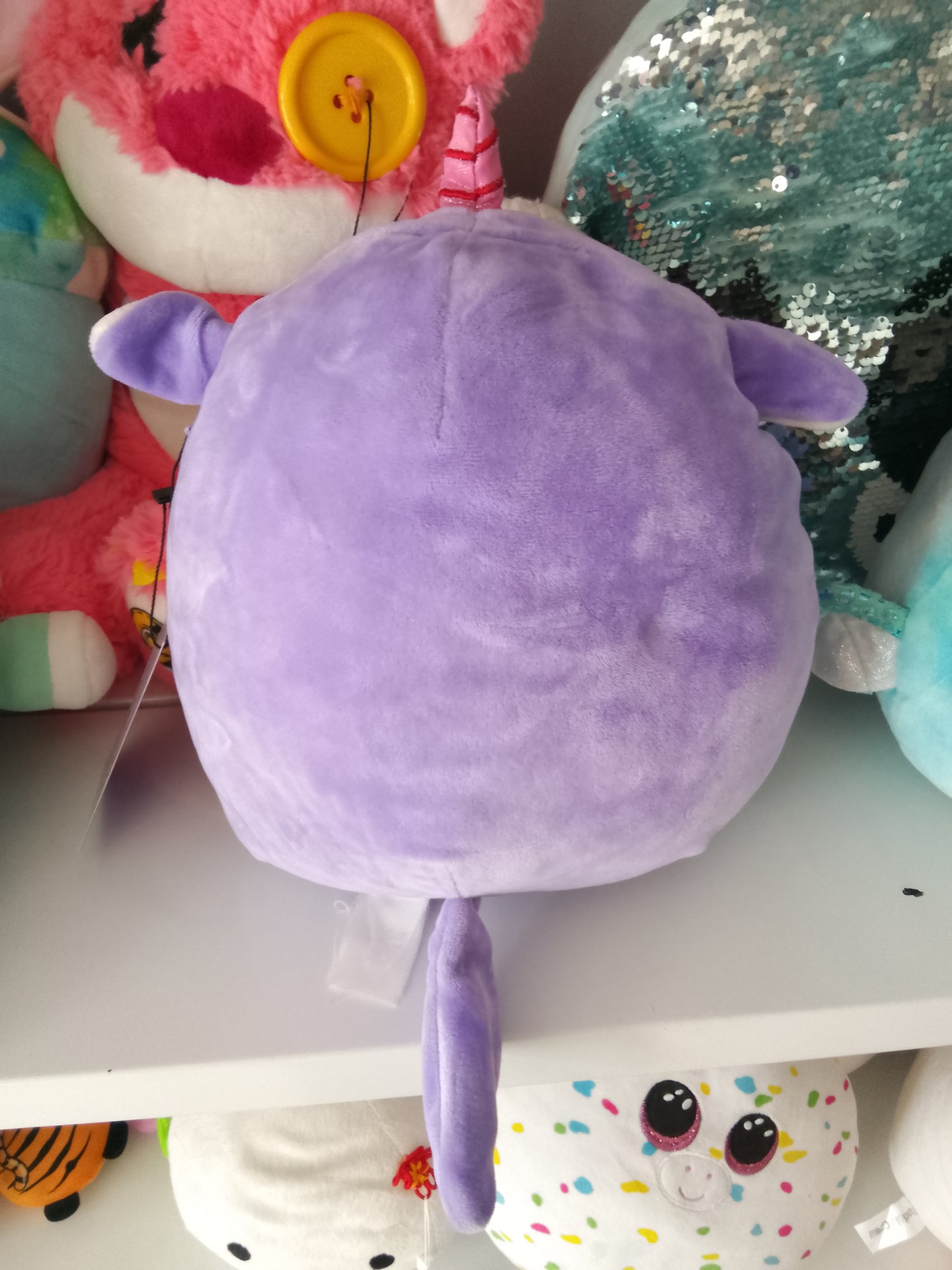 Squishmallows Astrid The Unicorn with Sleepy Eyes plush toy.