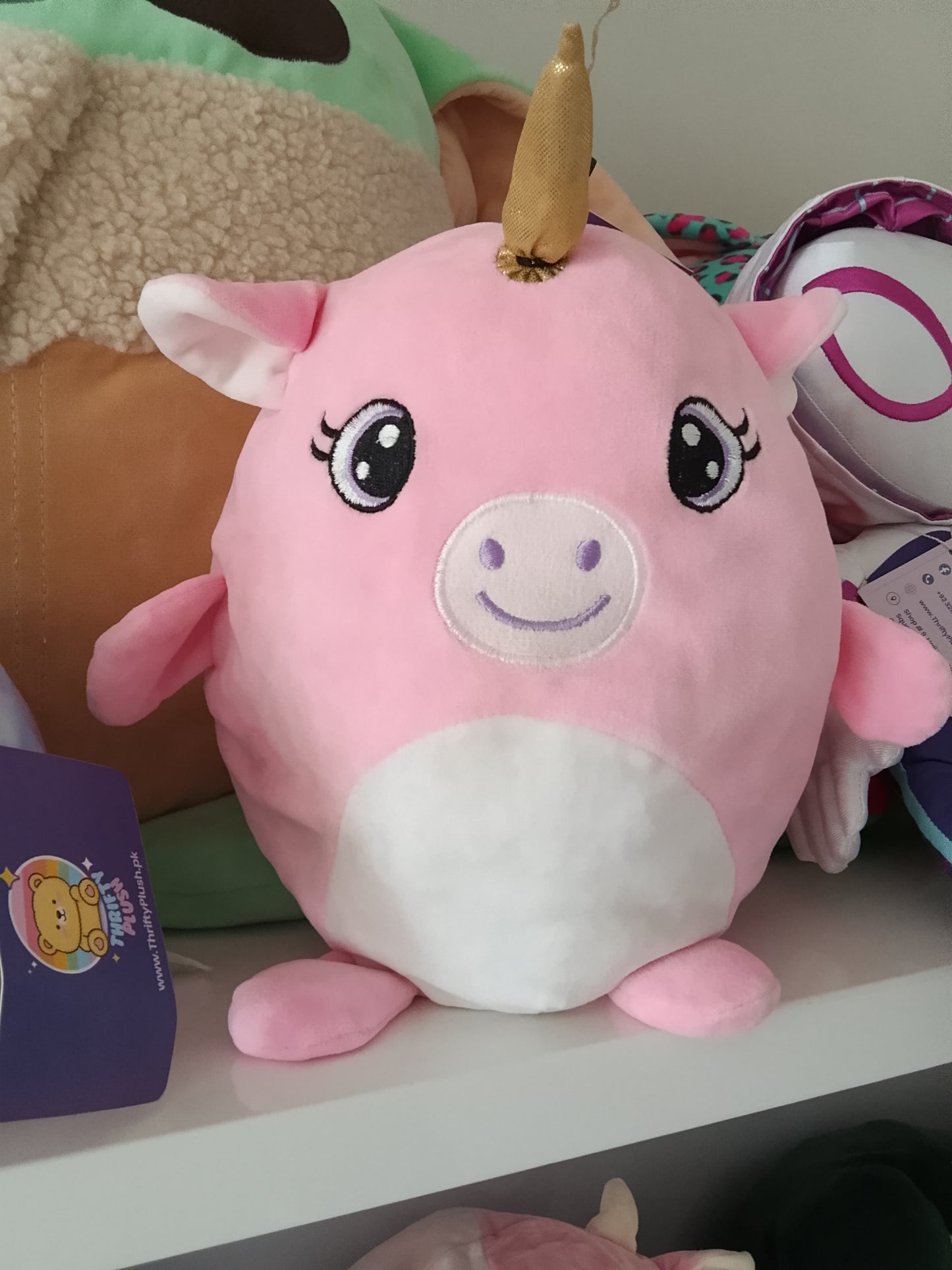 Pink unicorn plush pillow toy.