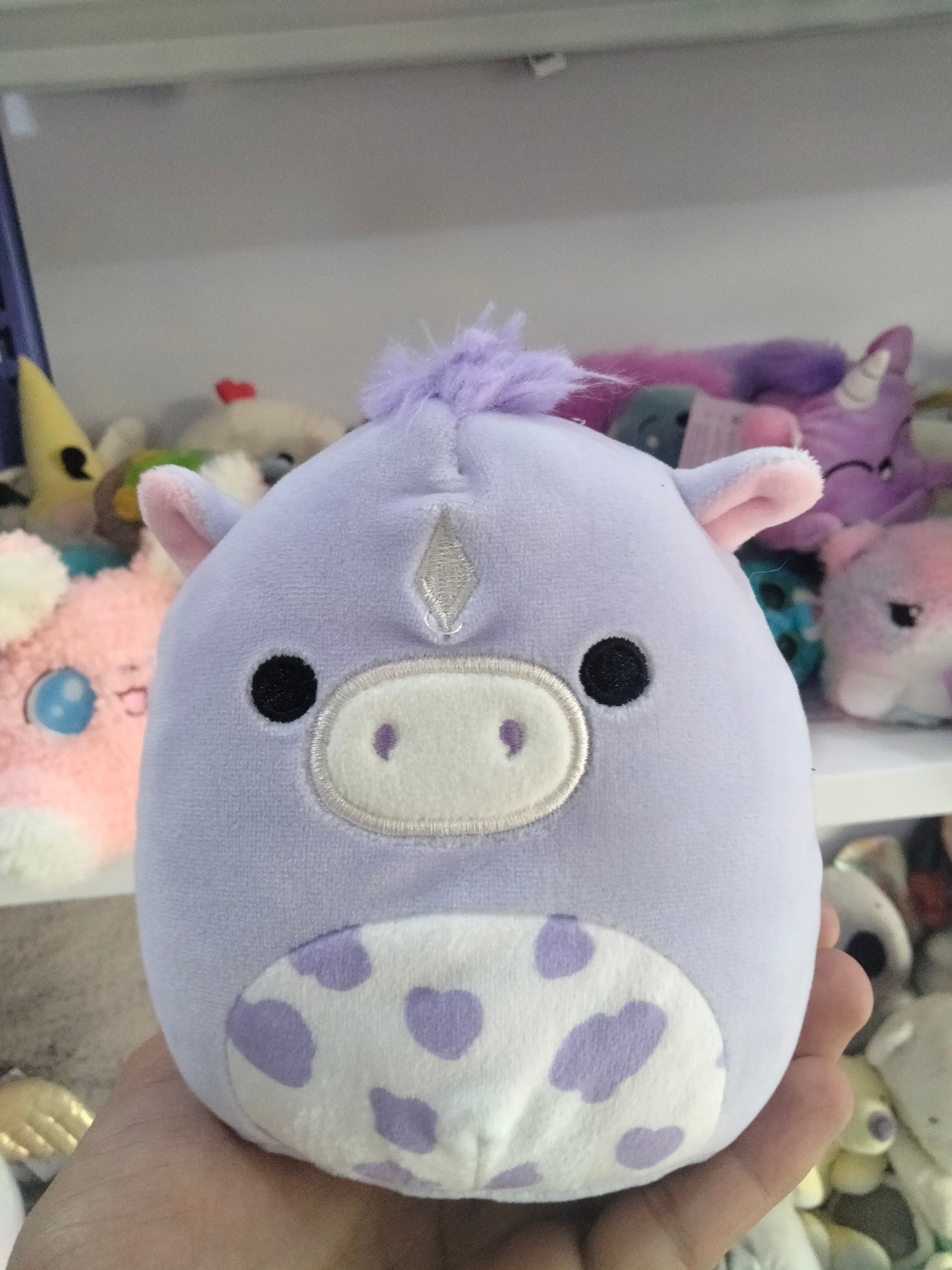 Squishmallows plush toy featuring the character Meadow, the purple horse.