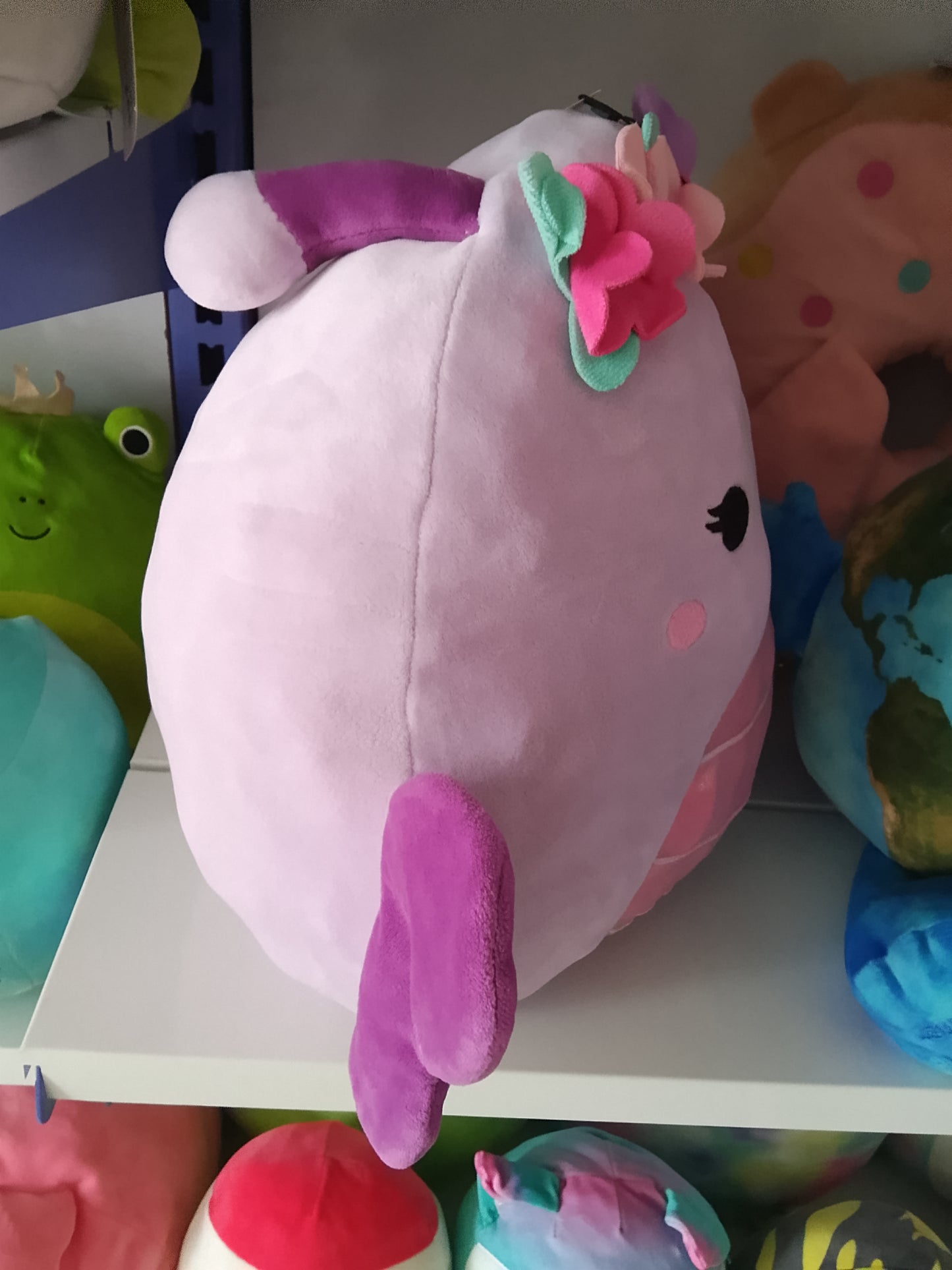 Squishmallows Brenda the Butterfly purple color, pink belly, and decorative flower crown plush toy.
